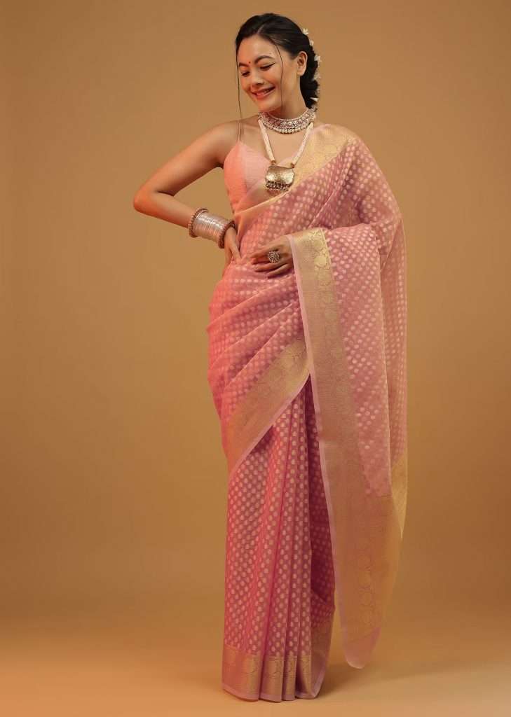 A woman posing for a photo wearing a Morning Glory pink saree in pure handloom cotton and Banarasi chanderi