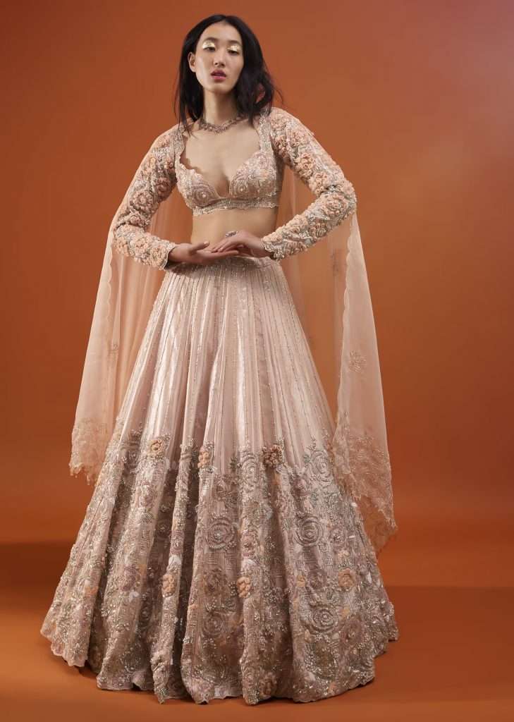 Woman posing for a photo wearing Kalki Festive Silver Pink Peony Lehenga