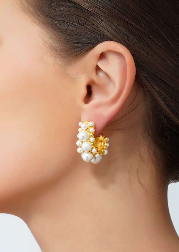 Woman posing for a photo while wearing to sleep 22K Bubble Hoops Earrings with White Shell Pearl