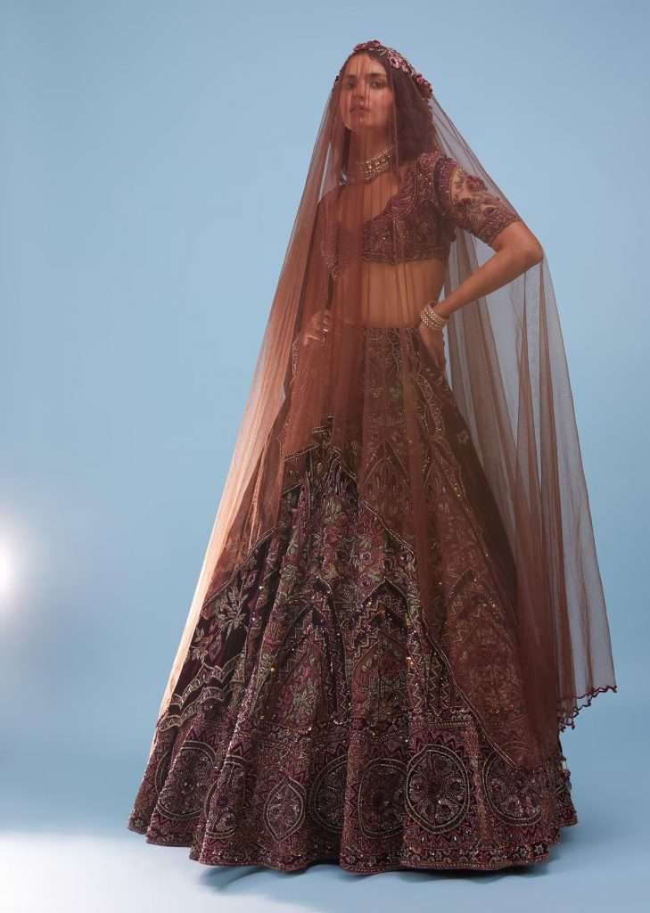 Kalki Shyamala Brown Architectural Lehenga in Velvet Raw Silk with Heavy Embroidery and Trailer Poses for a Photo - NOOR 2022