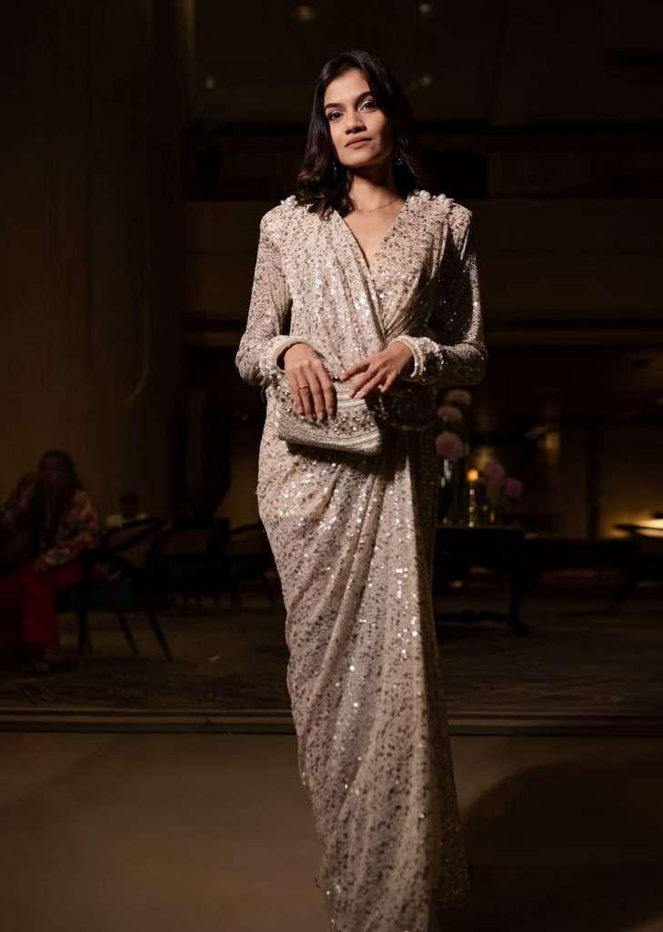 A woman posing for a photo wearing a Shreeja Bagwe Kalki ivory embroidered gown