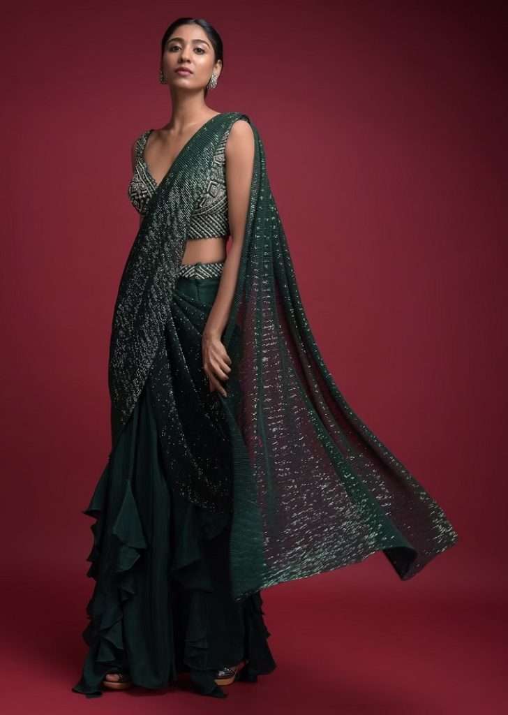 Women poses in Emerald Green Ready Pleated Saree In Crepe With Cascade Frill On The Hemline