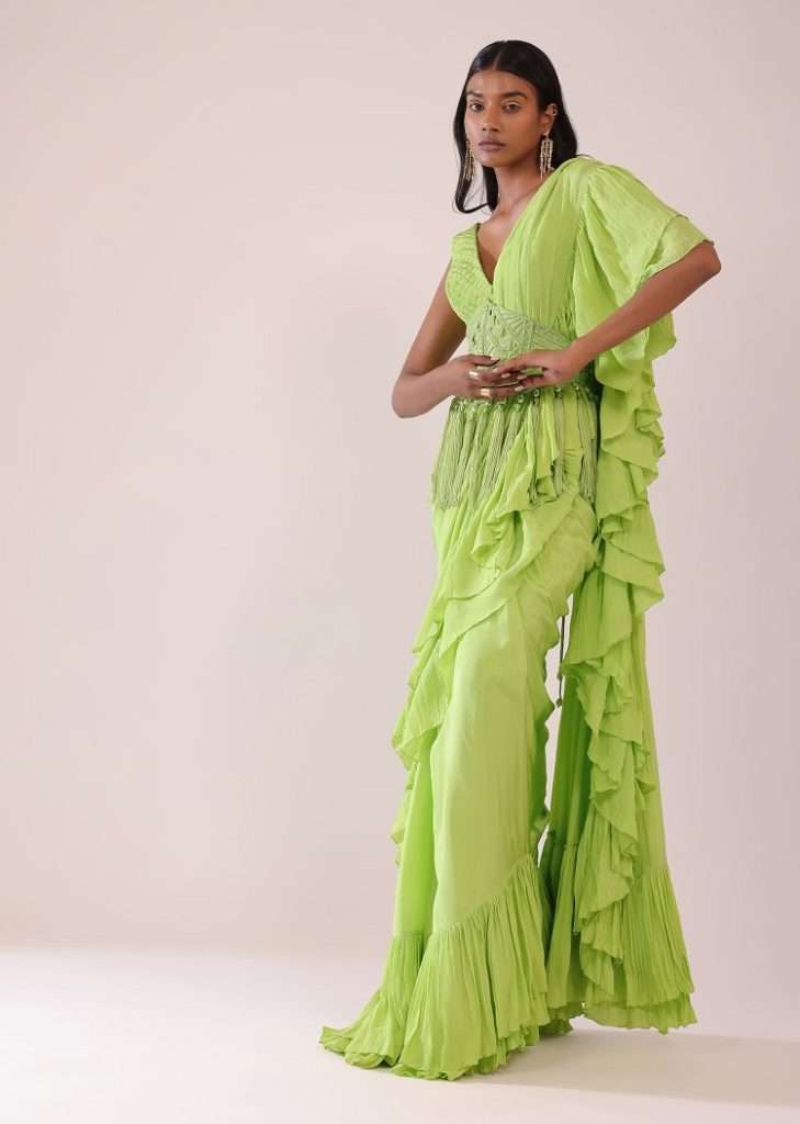 Women poses in Tea Green Stitched Saree In Crepe With Embroidered Belt