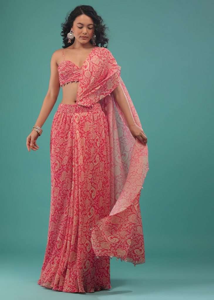 Women poses in Rouge Red Pink And Beige Printed Pre-Pleated Saree In Crepe