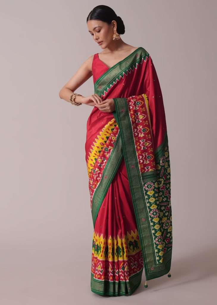 Women posing for photo wearing Red Patola Printed Embroidered Festive Saree In Dola Silk