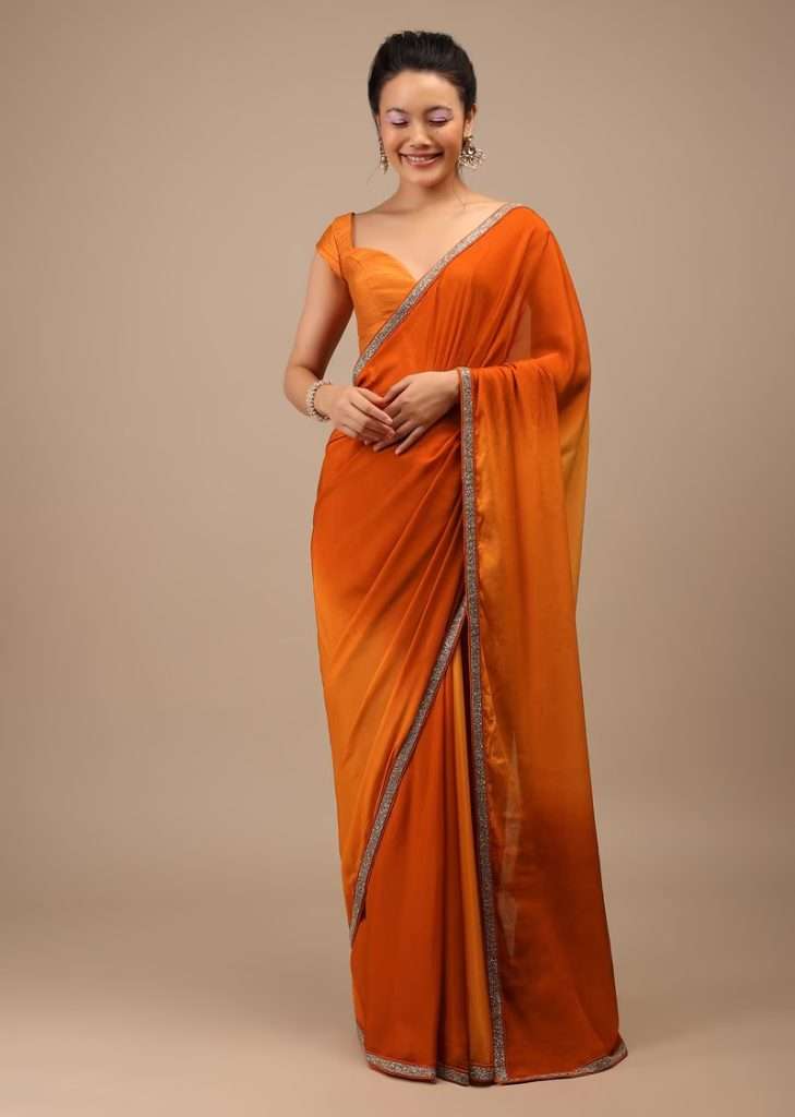 Women posing for photo wearing Spicy Orange Ombre Chiffon Saree With Buttis and Cut Dana Embroidery