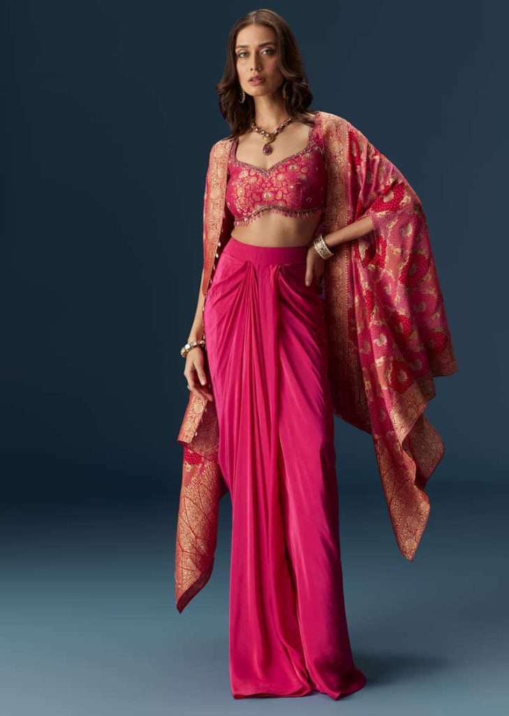 Festive Fashion 2025: Traditional Diwali Outfits for Men and Women 3 Rani Pink Embellished Blouse And Drape Skirt Set With Statement Cape