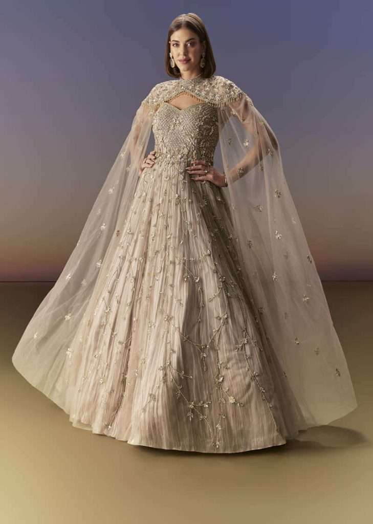 Beige Gown With Shoulder Cape And Rich Vertical Embroidery