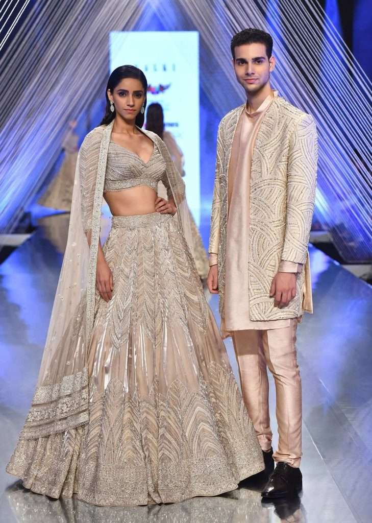 Oyster Organza Lehenga Adorned With Cut Dana Embroidery And A 3/4Th Sleeves Crop Top With A Deep V Neckline

