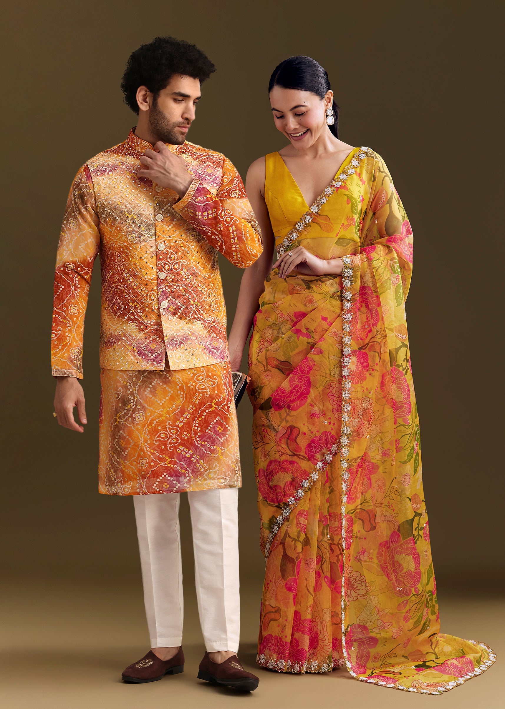Sunny Festive Couple Set – Yellow Organza Floral Saree With Beaded Border For Her And Orange Tie-Dye Jacket Kurta Set With Mirror Work For Him