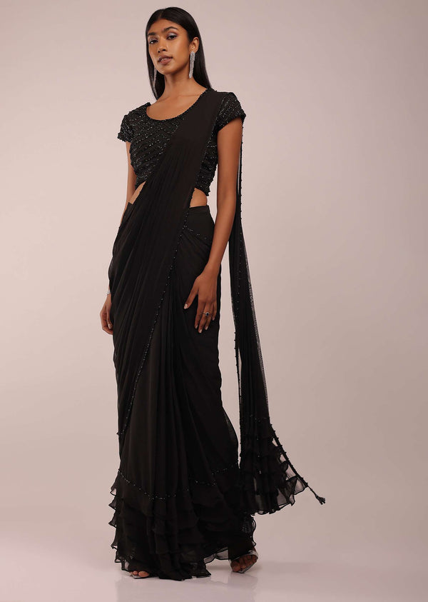 Pitch Black Saree With Three Tones Of Layered Frills On The Bottom Embellished In Stones And Sequins With A Tassel On The Pallu Corner