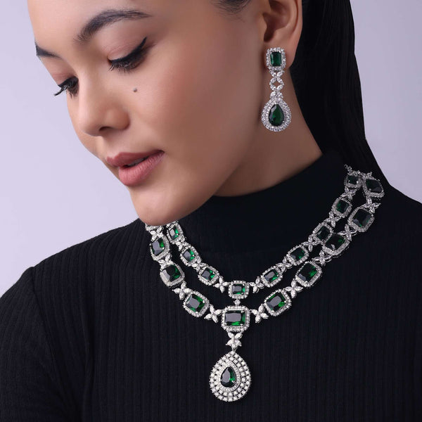 Silver Finish Long Necklace Studded With Faux Diamonds And Emerald Stones